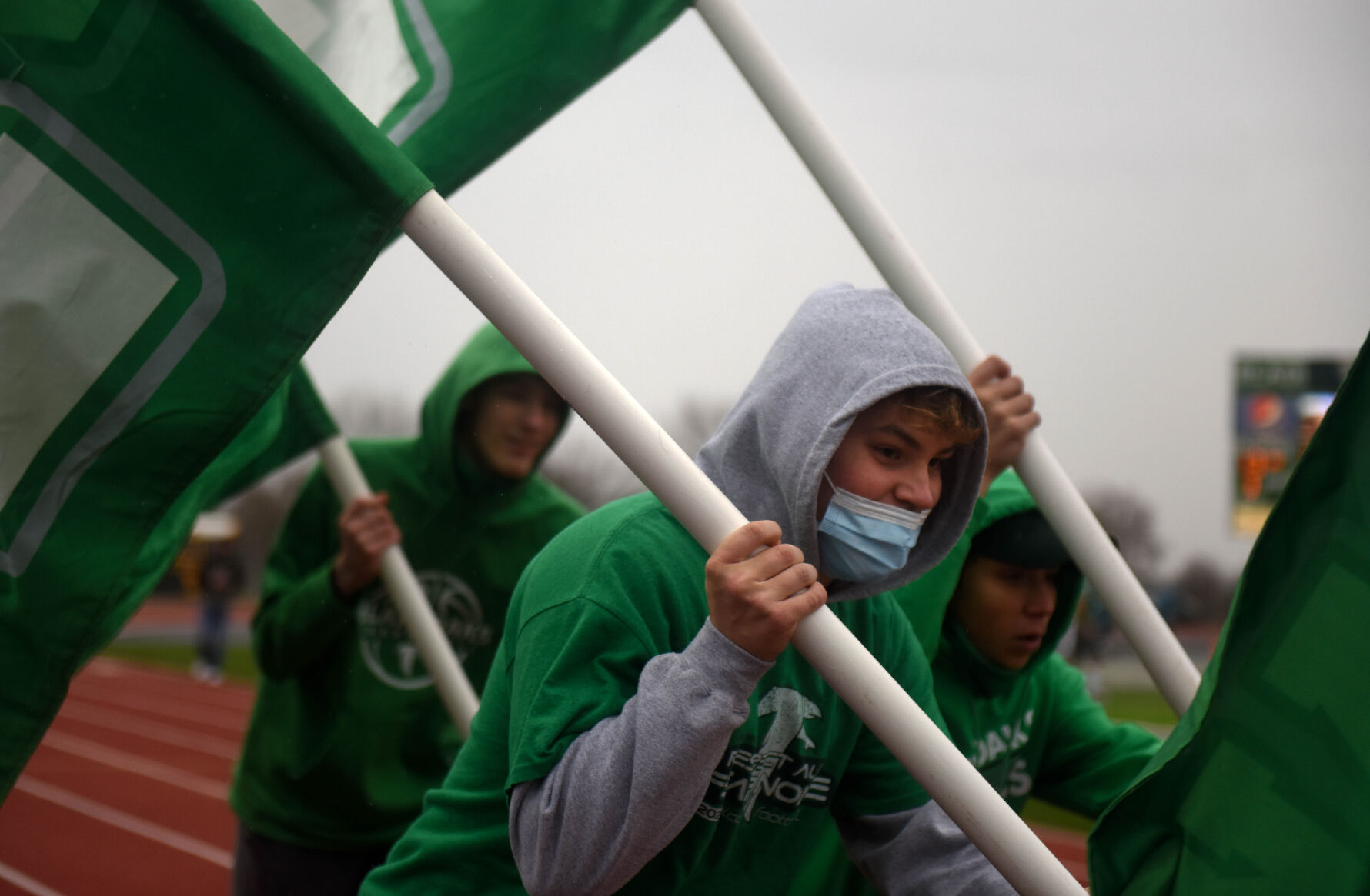 Blair Oaks senior Josh Isaacs runs with a flag to celebrate a touchdown